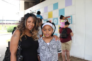 Cynthia Bernadine volunteers at the Community Design Day in Laurelton with her daughter, Mikayla
